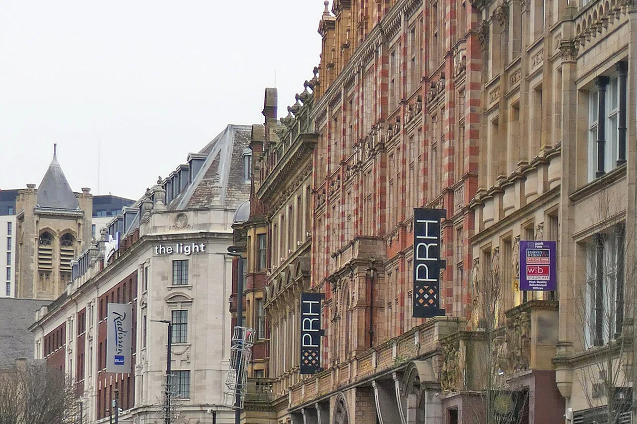 A tall stone office building on Park Row in Leeds