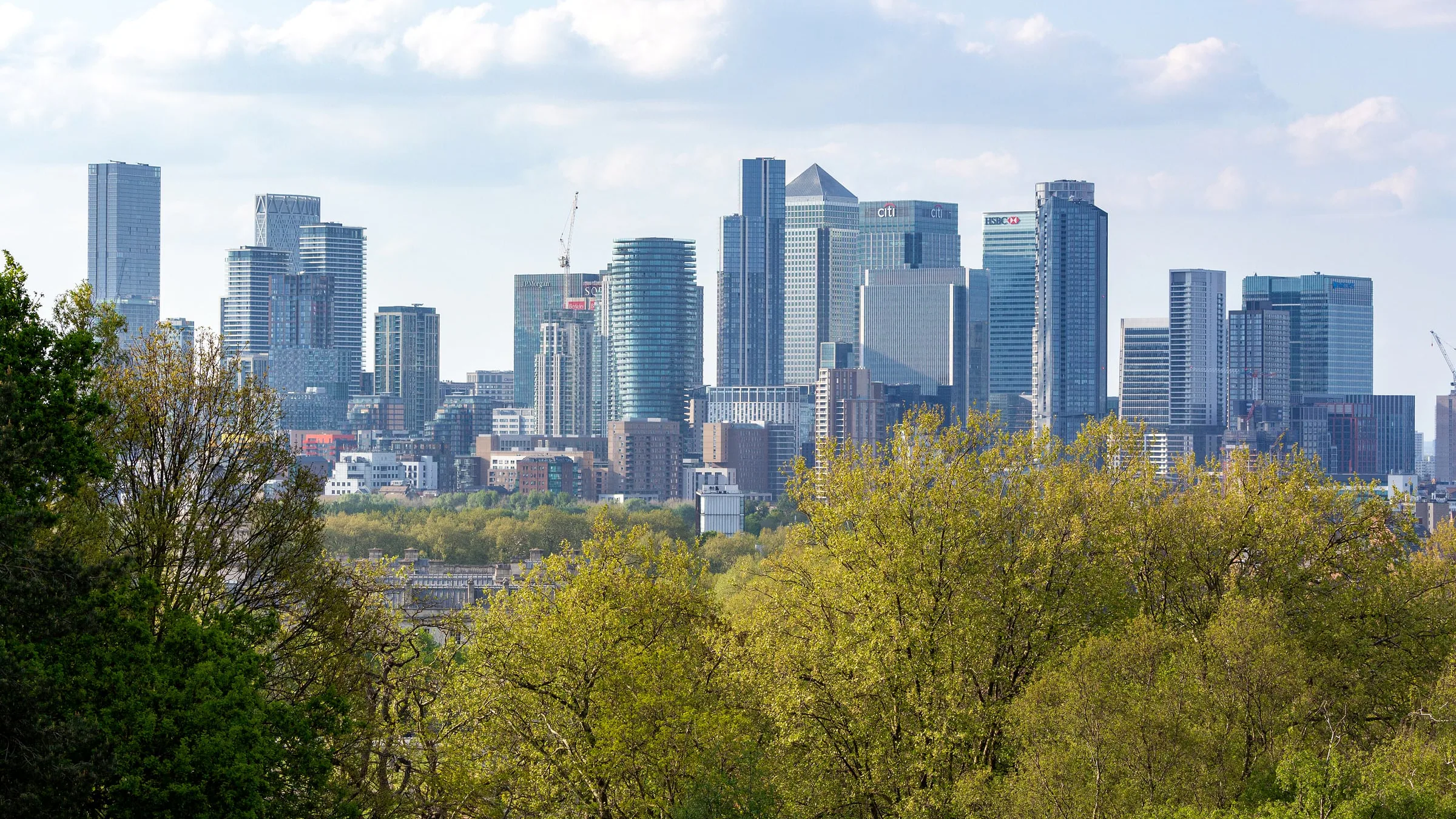 The Canary Wharf towers seen over the trees from Greenwich Park in spring