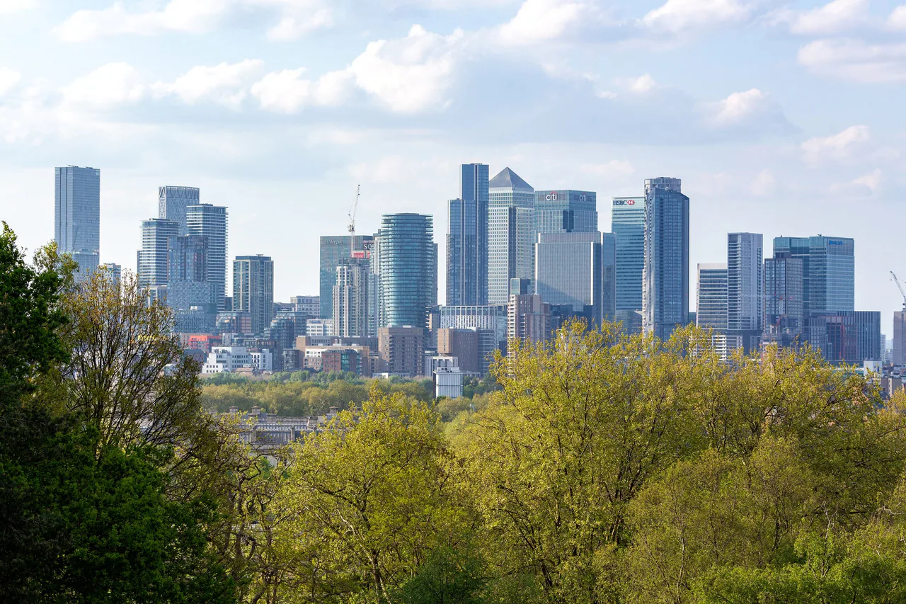 The Canary Wharf towers seen over the trees from Greenwich Park in spring