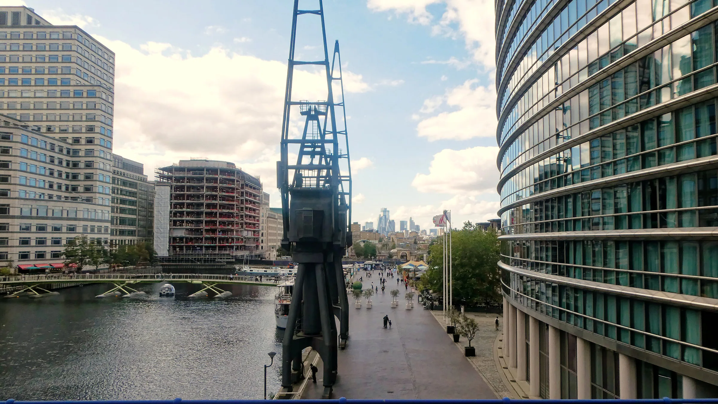 The waterside promenade at West India Quay beside North Dock, with Canary Wharf towers